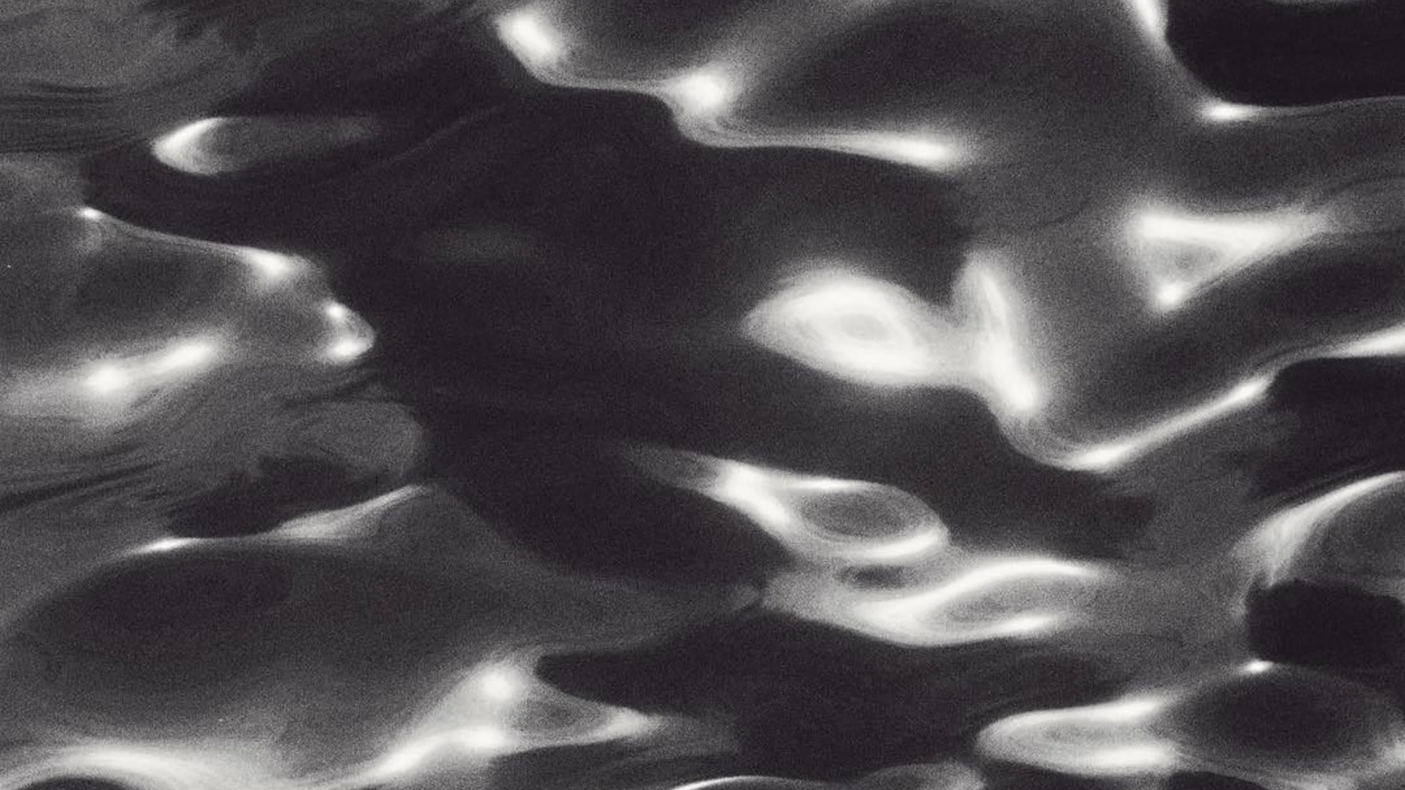Close-up of wavy metal surface with reflections