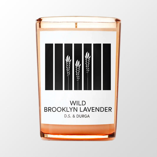 glass candle vessel, light orange and brown, white label with black text, black and white imagery of strands of lavender